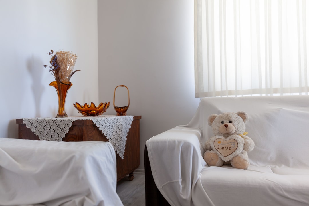 a cozy living room with a teddy bear and decorative vases on a table